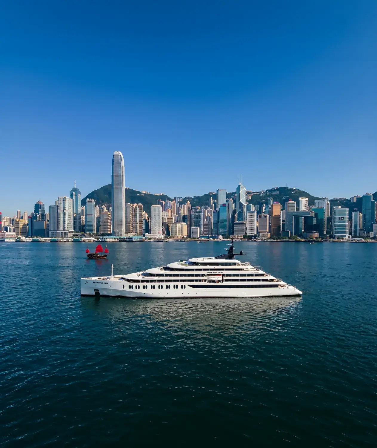 Scenic Group Jubiläum: 40 Jahre Luxuskreuzfahrten und neue Flotte bis 2028 Luxusyacht Emerald Xara der Scenic Group im Hafen von Hongkong, KI-generiertes Rendering